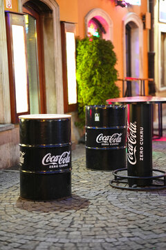Wroclaw, Poland, 12.21.2024. Barrels used for a street cafe, branded as advertising elements for the drink Coca-Cola Zero Cukru (which in Polish means "Coca-Cola without sugar")