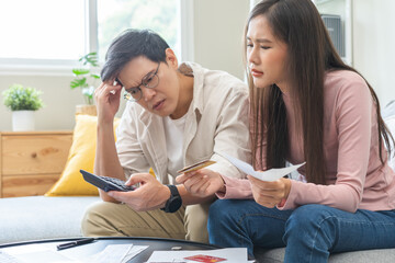 Stressed financial owe asian young couple love sitting suffer, stressed and confused by calculate...
