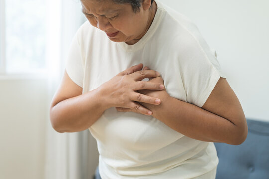 Chest pain, attack chest, emergency heartbeat asian senior woman holding hand on chest, suffering symptom from pain, heart disease problem of aged anxiety cardiac. Health care of cardiology concept.