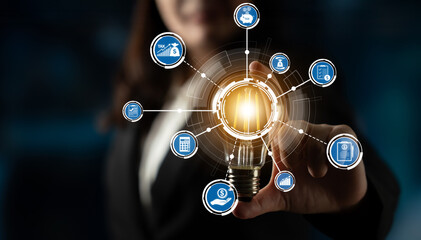 A businesswoman holds a glowing light bulb symbolizing innovation, surrounded by iconic representations of technology and ideas, indicating the power of creativity in the workplace. Crux © InfiniteFlow