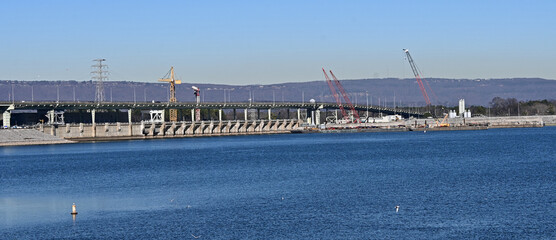 landscape photo of a dam and bridge over a river