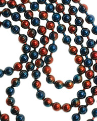 Metallic red and blue bead chain on white background