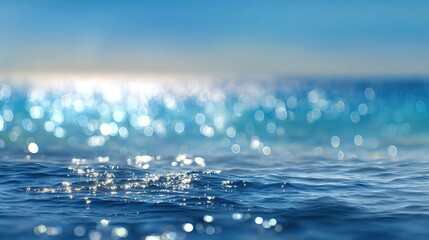 Glistening ocean waves reflecting sunlight with beautiful bokeh effect on a clear day