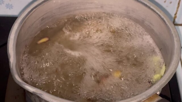Boiling Ginger to Make Traditional Herbal Drink Wedang Jahe