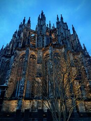 Gothic Cologne Cathedral close-up in the city of Cologne, Germany, Europe December 19, 2025. Indoor photo of Cologne Cathedral, back of the building. Against a blue sky background.View from below, 