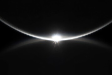 Vibrant sunrise over a distant planet's horizon, bright starburst and atmospheric glow