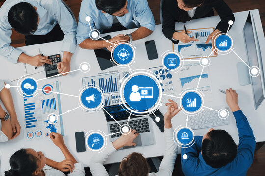 Top view analyst team utilizing BI Fintech to analyze financial data at table in meeting room. Analytic BI dashboard power on paper for business insight and strategic marketing planning. Prudent Amity - Powered by Adobe