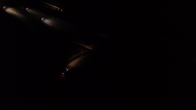 Aerial Night View of Moving Cars with Light Trails on Highway Interchange