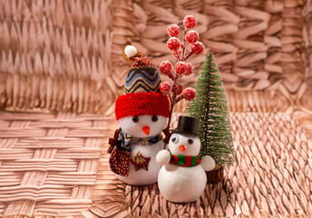 Snowmen near a Christmas tree. Macro composition.
