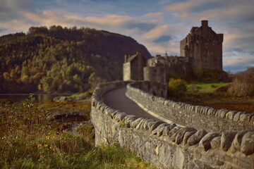 Selective focus image of Eilean Donan tidal island-castle linked to the mainland by a stone footbridge, Beinn Fhada in background. Dornie-Scotland-190