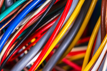 Bundles of multicolored cable wires in electrical installations, close-up view