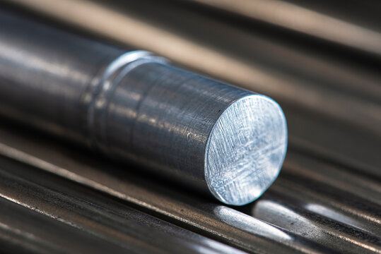 Steel rod close-up against a toned industrial background, a product of the heavy metallurgy industry