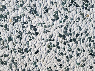 Close up of white and gray pebble stone wall texture background