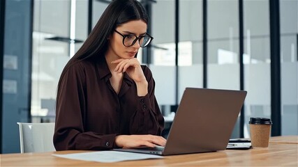 Focused Businesswoman: Working on Laptop - Office Environment and Productivity.

 - Powered by Adobe