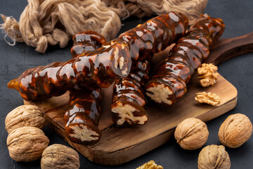 Walnut sausage dessert made with grape molasses and walnuts. Walnut sausage on black background