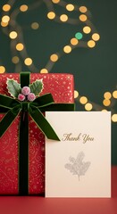 Elegant Christmas gift box with ribbon, thank you card, garland and winter decor in the background, perfect for advertising, branding and seasonal marketing projects.