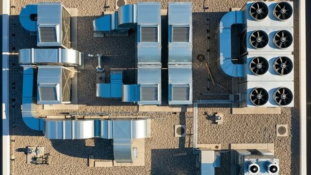 Industrial HVAC units spinning on clean commercial building rooftop