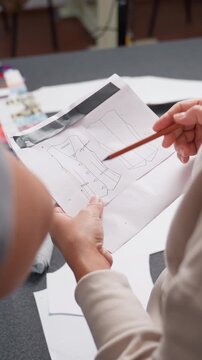 Detailed measurement planning, Careful alignment and planning for accurate fitting and design, Zoomed in view of pattern markings with blurred color samples in backdrop for precise measurement