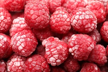 Frozen ripe raspberries as background, above view