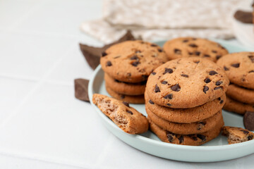Delicious chocolate chip cookies on light table, closeup. Space for text