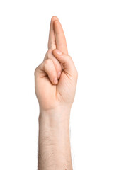 Man crossing fingers on white background, closeup