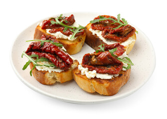 Delicious bruschettas with cream cheese, sun-dried tomatoes and arugula isolated on white