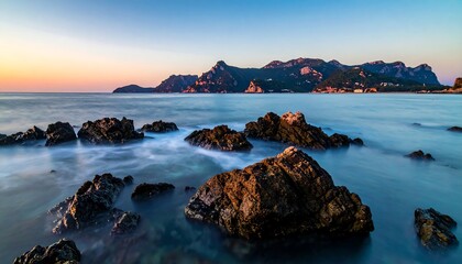 Sunrise over rocky shoreline