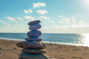Balancing stones on the sea shore. Summer vacation concept