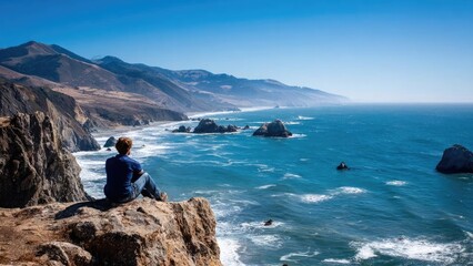 A person sits on a rocky cliff overlooking the blue sea and rugged coastline with distant hills. Concept Cliffside solitude, Ocean horizon, Rugged coastline, Serene portrait, Gentle sea breeze