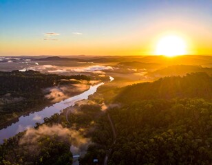 Sunrise over a valley with a river winding through