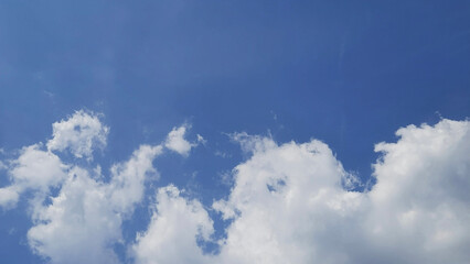 Bright Blue Sky with Soft White Cumulus Clouds