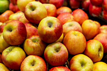 Organic market. Fresh red and yellow apples are beautifully arranged in vibrant display, showcasing their glossy skin and natural colors, creating an inviting atmosphere for shoppers at market