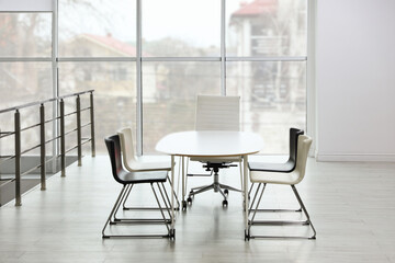 Stylish chairs and table in office. Interior design