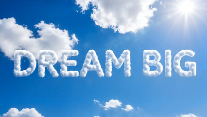 Cloud letters forming the phrase 'Dream Big' in blue sky  