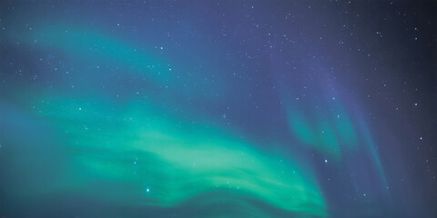 Soft teal and blue aurora veils drifting across a star-filled polar sky, blending gently with deep...