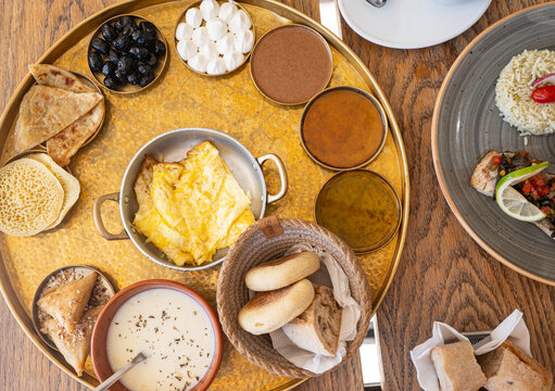 Traditional Moroccan Brunch Tray with Eggs, Bread and Tea