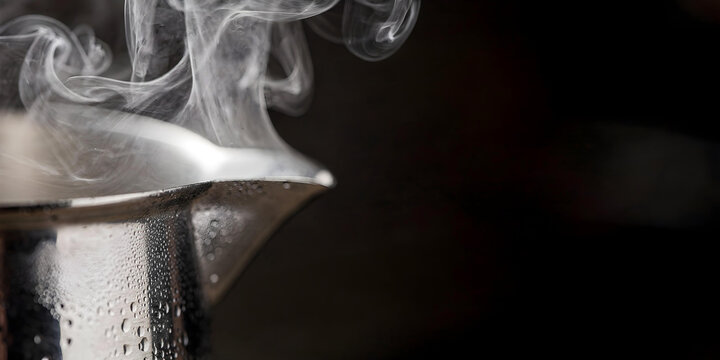 Close-up of steel kettle or cezve spout with thick white steam rising against dark background. - Powered by Adobe
