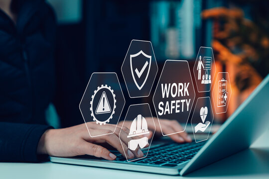 Woman using laptop with interface showing work safety, protection, training, risk management, compliance, personal protective equipment (PPE), and healthcare icons for workplace safety concept.