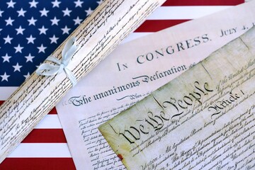 Constitution of the USA with US flag. Aged historical documents Washington DC on American...