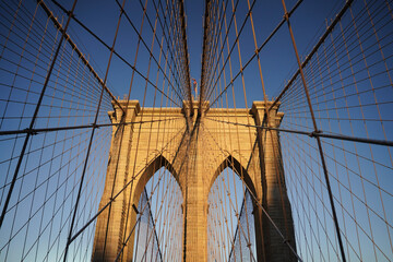 Fototapeta premium Architectural detail of the Brooklyn Bridge stone arches and suspension cables in New York City