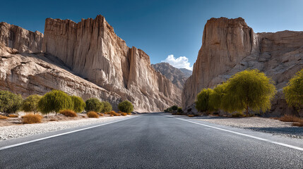 Empty road stretches through desert canyon with dramatic rocky cliffs, blue sky, and green trees, evoking adventure and solitude