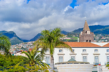 Portugal, Madeira, 13.12.2025: Funchal Skyline with Mountains, Palm Trees and Historic Cathedral Tower