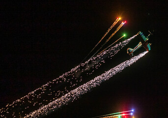 fireworks launched from an airplane at an airshow