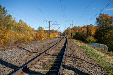 Double Railway Tracks Curving Through Colorful Autumn Forest in Paneriai, Lithuania