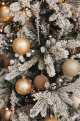 christmas background of white fir tree branches with golden balls and christmas lights. holiday background. new year. christmas tree.