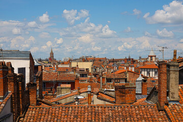 A panoramic view of Toulouse, showcasing terracotta rooftops and historic structures. The vibrant...