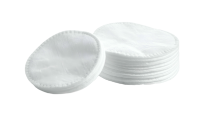 Close-up of cotton cosmetic pads, white, round, and stacked on a black background