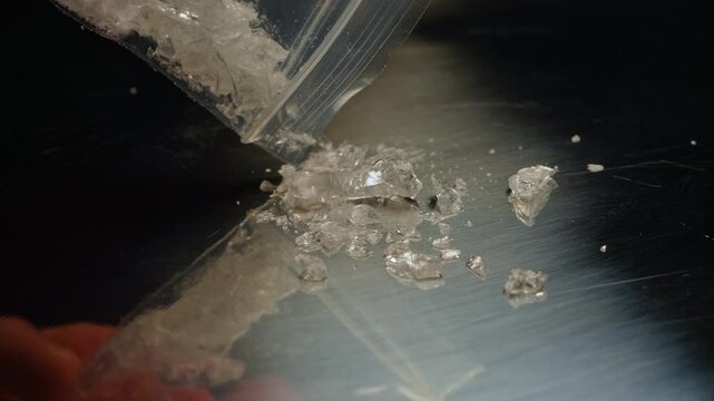 Methamphetamine drug in a plastic bag. Crystal meth or methamphetamine a recreational and highly potent and addictive drug. Crack cocaine in hard form of crystals. Addiction and drug trafficking.