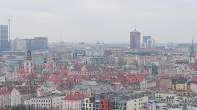 A drone view of Poznan's panorama on a foggy and cloudy day. The fara, city hall, university of economics, and the old town are visible.