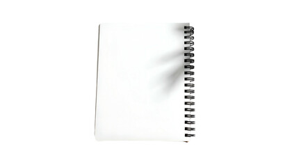 A pristine white spiral-bound notebook against a stark black background, slightly angled